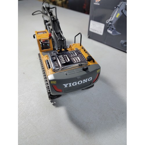 19 - A Boxed New remote control excavator by Yigong in full working order with metal bucket and engine co... 