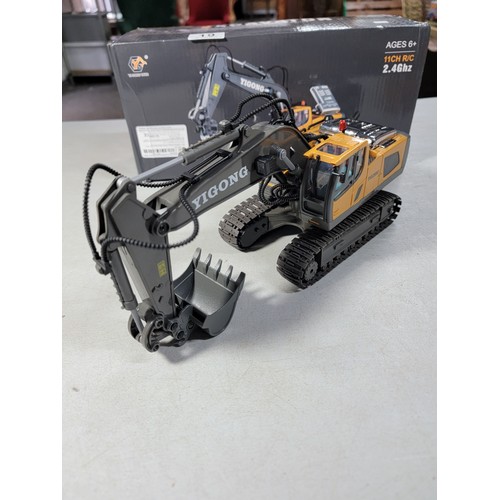 19 - A Boxed New remote control excavator by Yigong in full working order with metal bucket and engine co... 