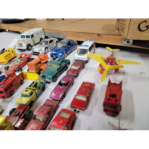 29 - Large quantity of diecast vehicles inc a subaru imprezza, rescue helicopter, fire engine, landrover,... 