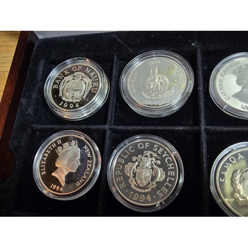 159 - A wooden cased collection of 12x solid silver proof coins, 11 are 1oz silver coins and 1 half ounce,... 