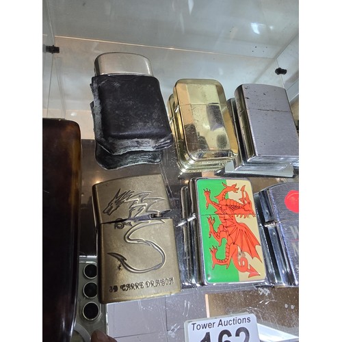 162 - A collection of 8 vintage petrol lighters along with a vintage faux tortoise shell cigarette case in... 