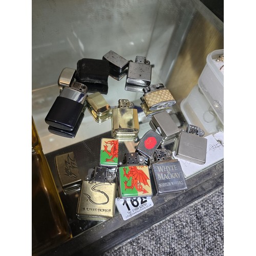 162 - A collection of 8 vintage petrol lighters along with a vintage faux tortoise shell cigarette case in... 