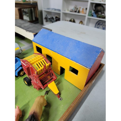 44 - A toy wooden farm set with 3 out houses, along with a large quantity of farm animals, zoo animals, f... 