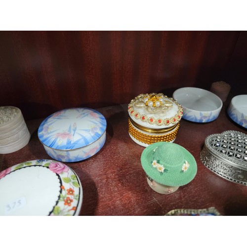 69 - A large quantity of ceramic and glass trinket boxes most with lids, inc sequin decorated trinket box... 