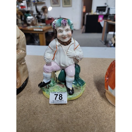 78 - A genuine antique Staffordshire figure 'The Jolly Farmer' sitting on a keg, along with a Royal Doult... 