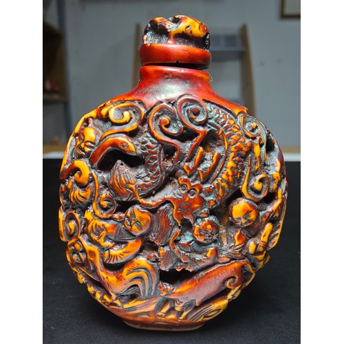 235 - A good vintage Chinese carved snuff bottle featuring intricate deep carved scene to the sides featur... 