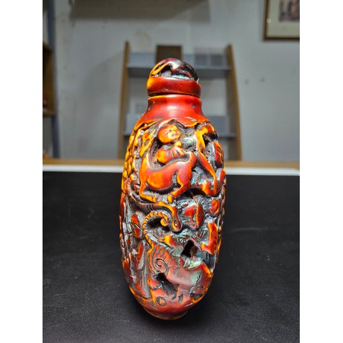 235 - A good vintage Chinese carved snuff bottle featuring intricate deep carved scene to the sides featur... 