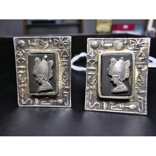 249 - Pair of Egyptian solid silver cufflinks, having an ornate panel design with a border of Hieroglyphic... 