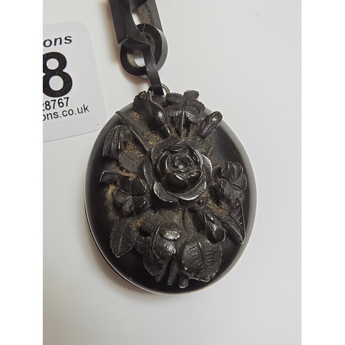 238 - A good Victorian Whitby jet mourning locket, beautifully carved to the front featuring a deep carved... 