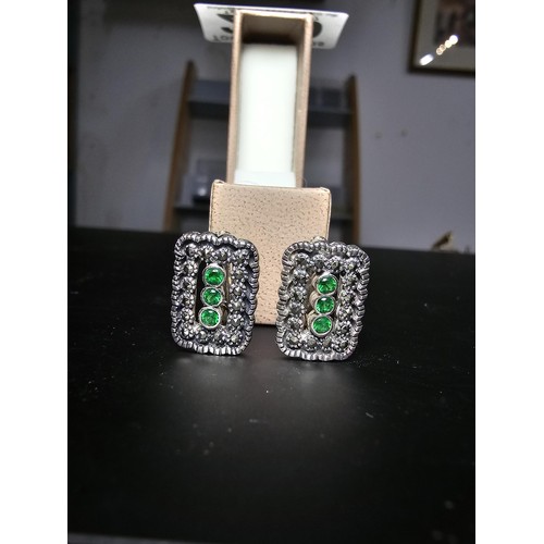 210 - Unused pair of stunning Art Deco style 925 silver earrings, inset with Marcasite stones and three vi... 