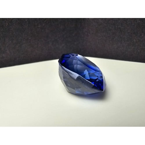 251 - A cased large lab created cushion cut faceted blue sapphire gemstone complete with its presentation ... 