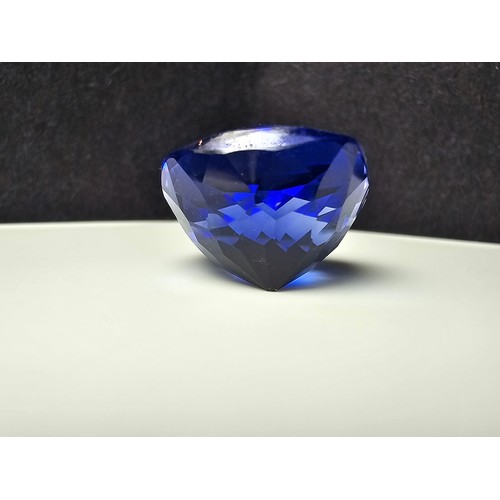 251 - A cased large lab created cushion cut faceted blue sapphire gemstone complete with its presentation ... 