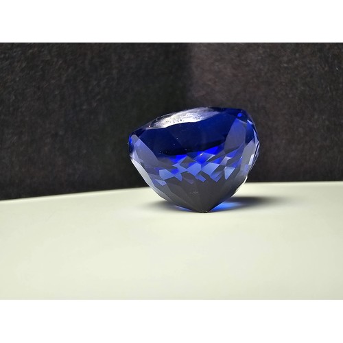 251 - A cased large lab created cushion cut faceted blue sapphire gemstone complete with its presentation ... 