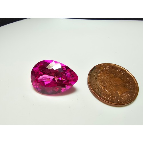 252 - A cased large lab created tear drop cut faceted pink sapphire gemstone complete with its presentatio... 