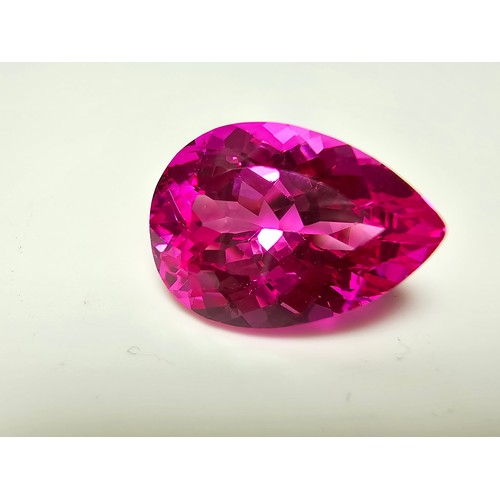 252 - A cased large lab created tear drop cut faceted pink sapphire gemstone complete with its presentatio... 