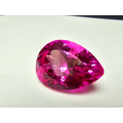 252 - A cased large lab created tear drop cut faceted pink sapphire gemstone complete with its presentatio... 