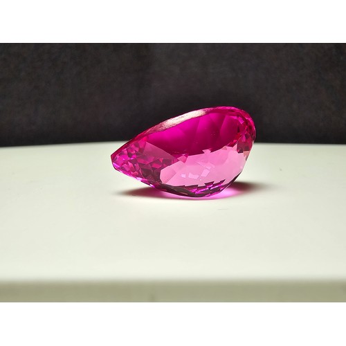 252 - A cased large lab created tear drop cut faceted pink sapphire gemstone complete with its presentatio... 