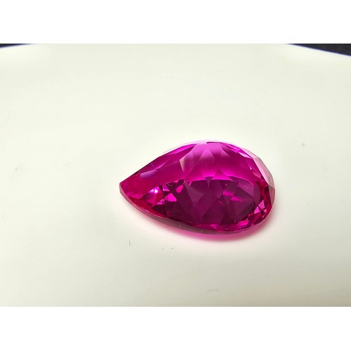 252 - A cased large lab created tear drop cut faceted pink sapphire gemstone complete with its presentatio... 