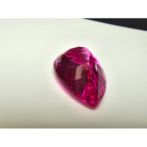 252 - A cased large lab created tear drop cut faceted pink sapphire gemstone complete with its presentatio... 