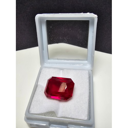 253 - A cased large lab created rectangular cut faceted red ruby  gemstone complete with its presentation ... 