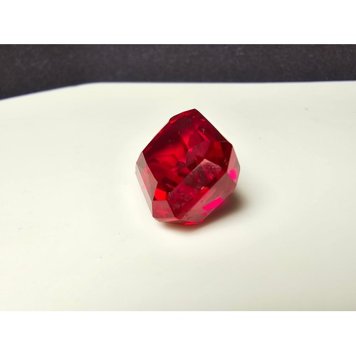 253 - A cased large lab created rectangular cut faceted red ruby  gemstone complete with its presentation ... 