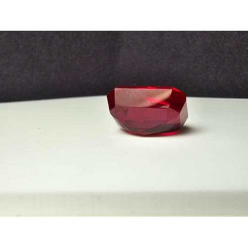 253 - A cased large lab created rectangular cut faceted red ruby  gemstone complete with its presentation ... 