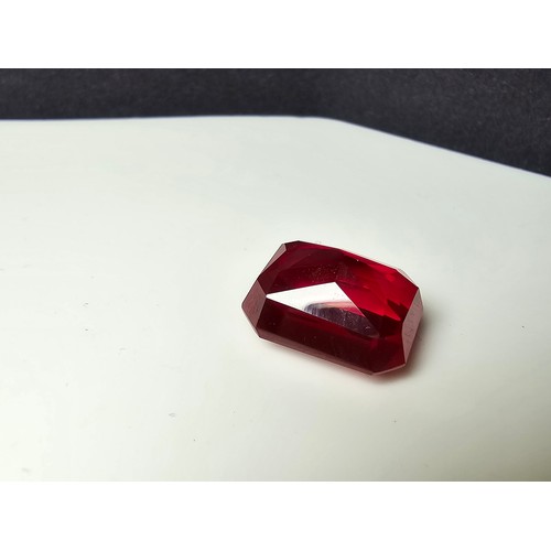 253 - A cased large lab created rectangular cut faceted red ruby  gemstone complete with its presentation ... 