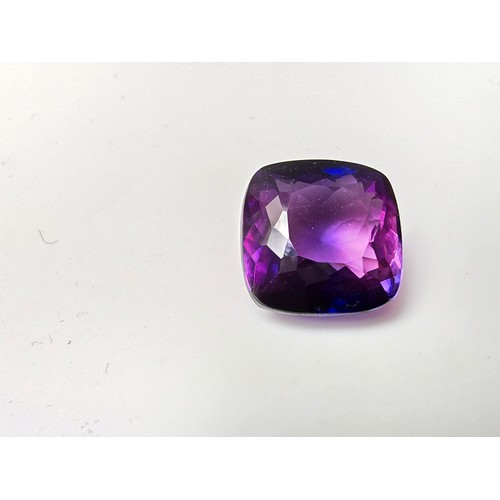 255 - A cased large lab created cushion cut faceted purple sapphire gemstone has a lovely blue to purple h... 