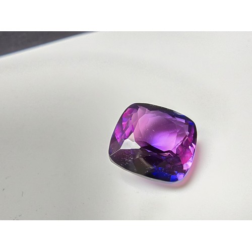 255 - A cased large lab created cushion cut faceted purple sapphire gemstone has a lovely blue to purple h... 