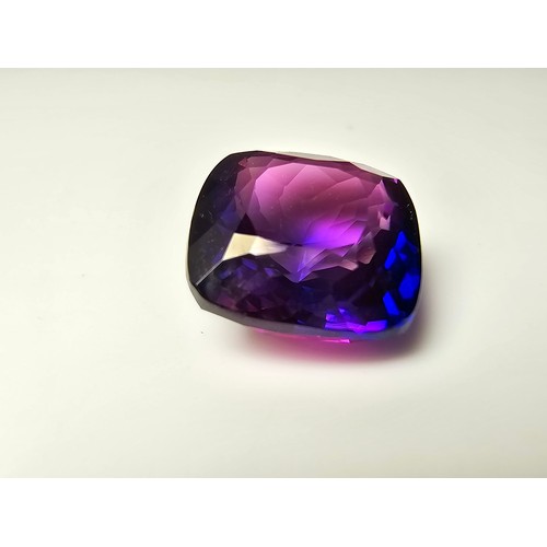 255 - A cased large lab created cushion cut faceted purple sapphire gemstone has a lovely blue to purple h... 