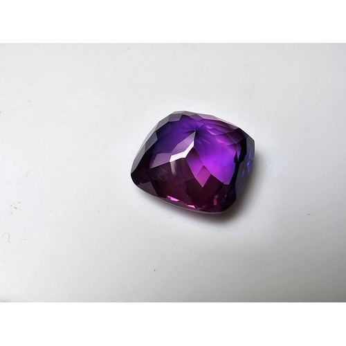 255 - A cased large lab created cushion cut faceted purple sapphire gemstone has a lovely blue to purple h... 