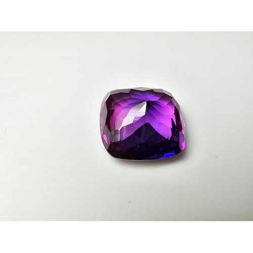 255 - A cased large lab created cushion cut faceted purple sapphire gemstone has a lovely blue to purple h... 