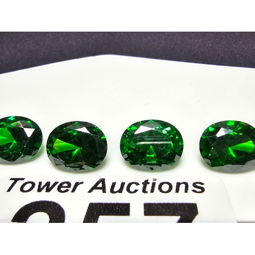 257 - A collection of 6x lab created faceted emerald gemstones, all oval cut. Length of 10mm, width 7mm, h... 