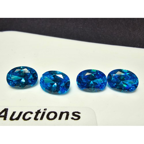 258 - A collection of 10x lab created faceted aqua marine gemstones, rectangular cut and oval cut stones. ... 