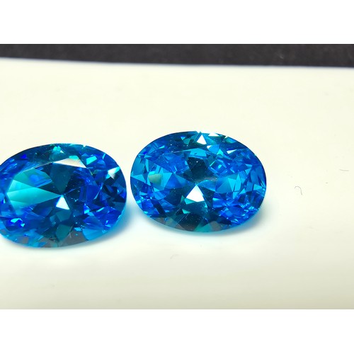 258 - A collection of 10x lab created faceted aqua marine gemstones, rectangular cut and oval cut stones. ... 