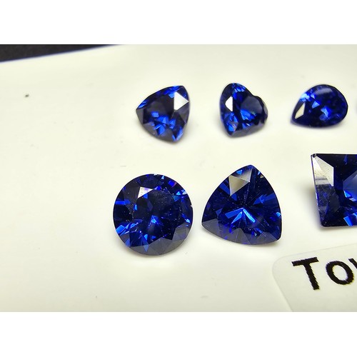 259 - A collection of 13x lab created faceted iolite gemstones, all of various shapes and sizes includes  ... 