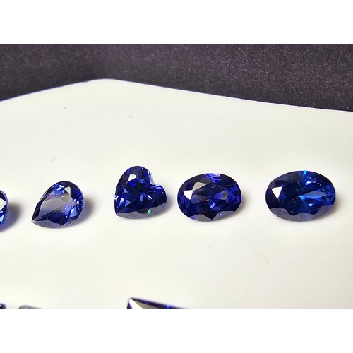 259 - A collection of 13x lab created faceted iolite gemstones, all of various shapes and sizes includes  ... 