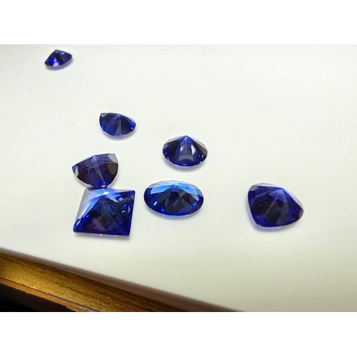 259 - A collection of 13x lab created faceted iolite gemstones, all of various shapes and sizes includes  ... 