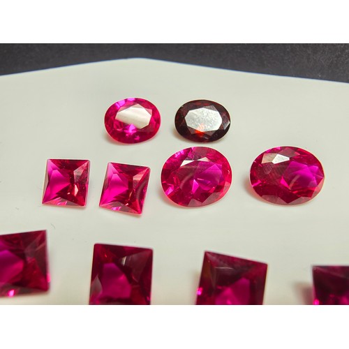 260 - A collection of 9x lab created faceted ruby gemstones along with a faceted almandine garnet gemstone... 