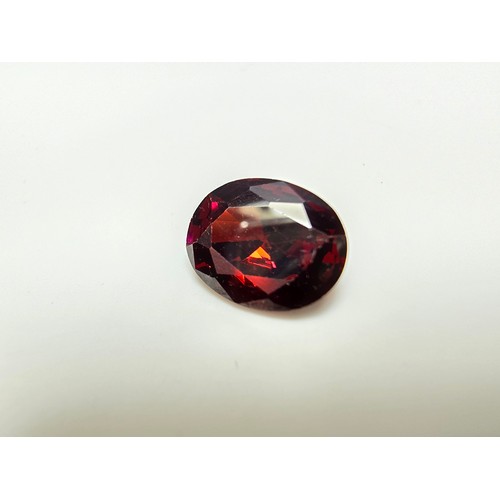 260 - A collection of 9x lab created faceted ruby gemstones along with a faceted almandine garnet gemstone... 