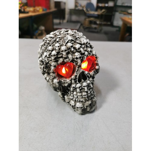 128 - Brand new resin ornate skull figure with light up heart eyes with original packaging. Battery operat... 