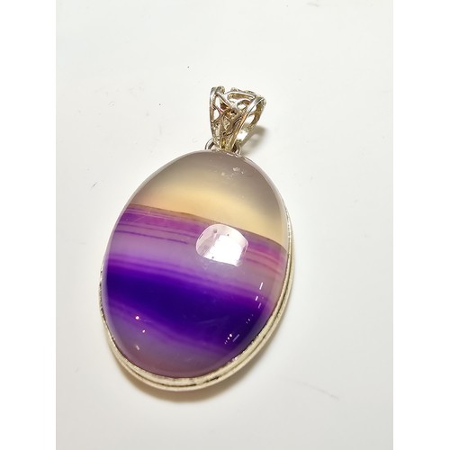 171 - A large 925 silver oval pendant inset with a  large natural agate stone with natural banding which i... 