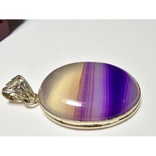 171 - A large 925 silver oval pendant inset with a  large natural agate stone with natural banding which i... 