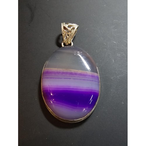 171 - A large 925 silver oval pendant inset with a  large natural agate stone with natural banding which i... 