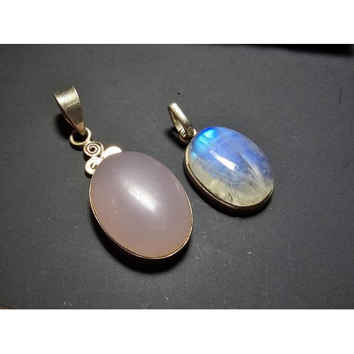 172 - A pair of pretty 925 silver pendants, 1 inset with a large oval rainbow moonstone which has beautifu... 