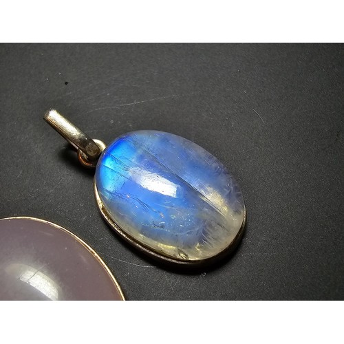 172 - A pair of pretty 925 silver pendants, 1 inset with a large oval rainbow moonstone which has beautifu... 