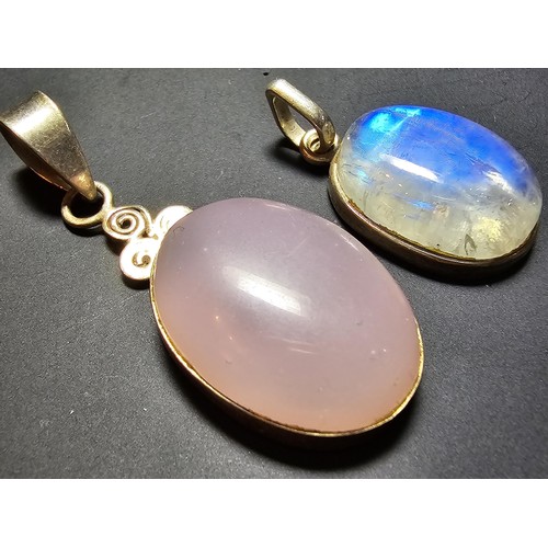 172 - A pair of pretty 925 silver pendants, 1 inset with a large oval rainbow moonstone which has beautifu... 