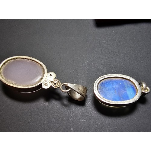 172 - A pair of pretty 925 silver pendants, 1 inset with a large oval rainbow moonstone which has beautifu... 