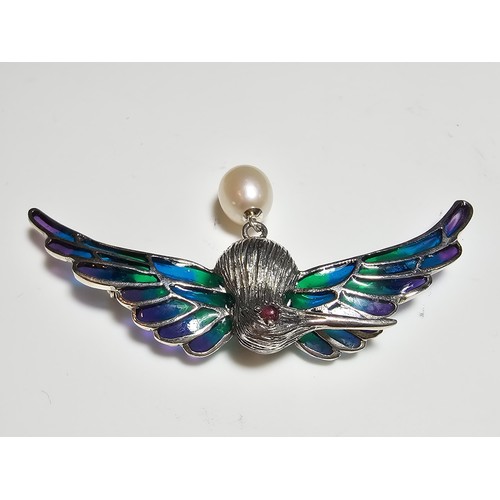 175 - A stunning 925 silver pique a jour bird formed brooch featuring colourful stained glass backing to t... 