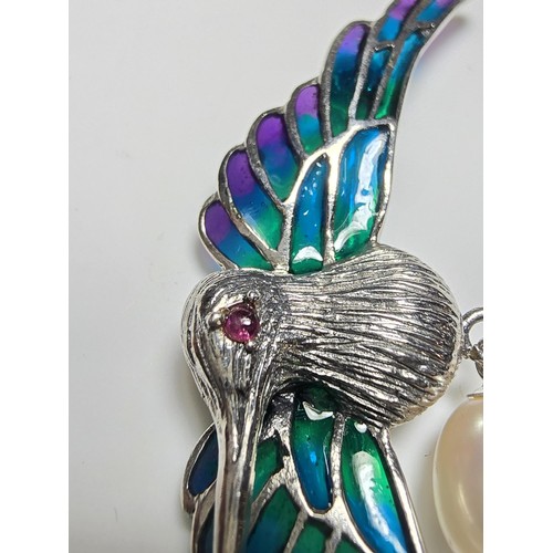 175 - A stunning 925 silver pique a jour bird formed brooch featuring colourful stained glass backing to t... 